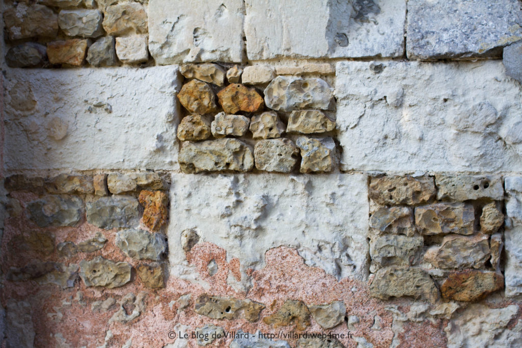 Appareillage de pierres et enduit d'un mur d'une église de l'Orne.